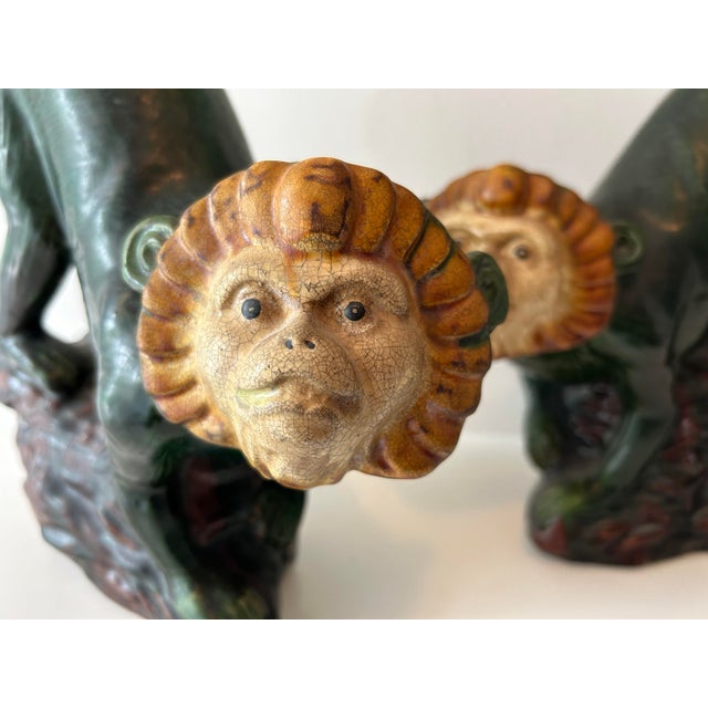 Pair of majolica-style ceramic monkey figurines. Finish is in rich green tones with brown accents, one can see the crackle...