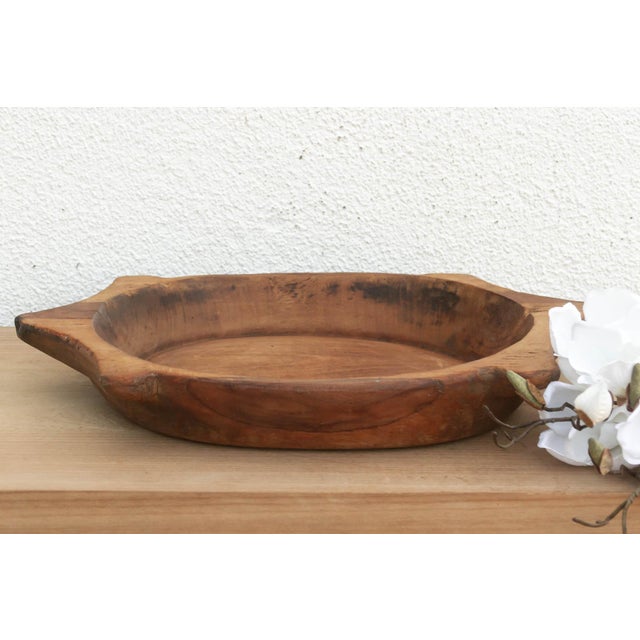 The sculptural form of this vintage bowl takes center stage. Carved from a single piece of solid hardwood, it features a...