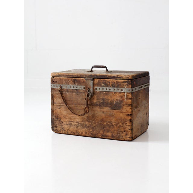 This antique primitive wood storage box features a weathered pine form, iron hardware, and an old hand-painted “VACUUM C”...