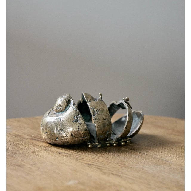 Bronze sculpture in segmented accordion style pieces. It can lay open or it can be closed up in the center via the hook on...