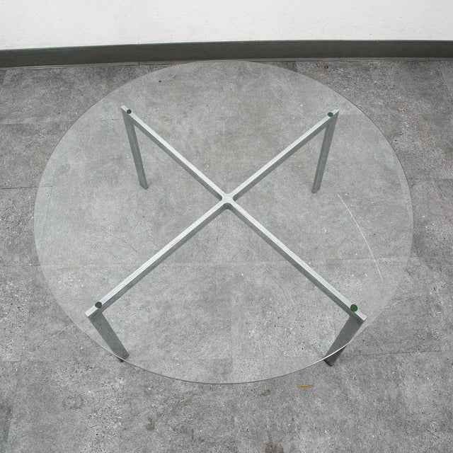Beautiful round x base metal coffee table with round glass top. Great addition to any home or space. This is an unsigned...