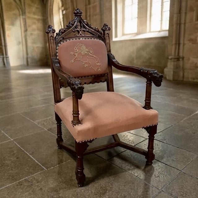 19th century French Gothic walnut armchair with embroidery features timeless design with visual appeal that includes...