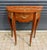 Refined and elegant, this French demi-lune side table is a timeless accent piece that showcases exceptional European...