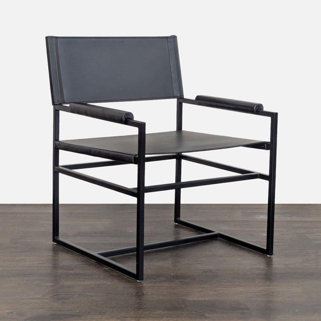 Metal square arm with leather rests. Fixed legs are finished in black. Metal tube frame provides exceptional structural...