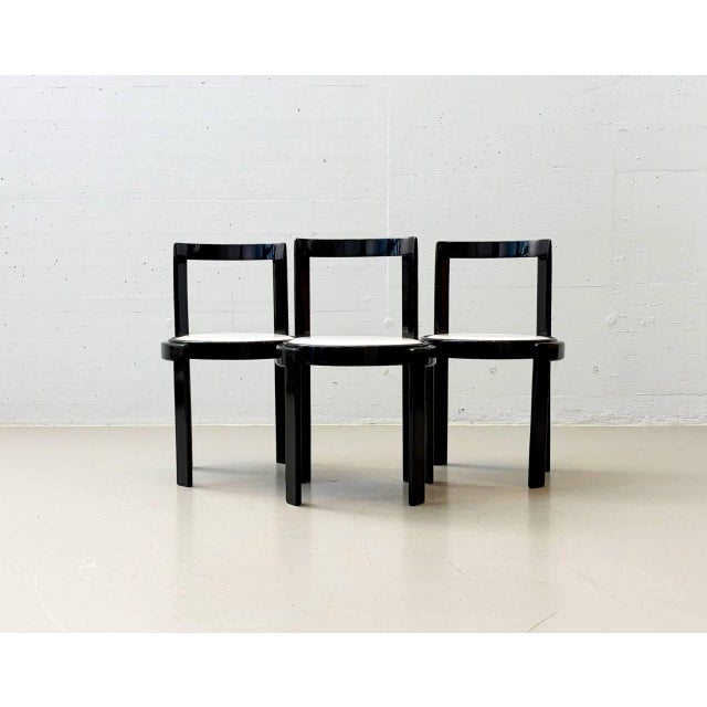 The side chairs were designed by gianfranco frattini. The chairs feature a clear, architectural design language with a...