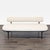 This CB2 sofa features a sleek and simple design with cream upholstery and black metal legs. The slim backrest and...