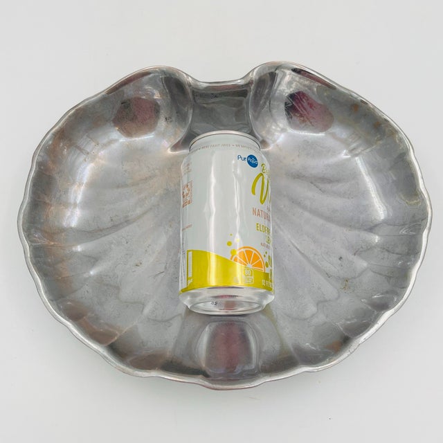 Add a touch of coastal elegance with this vintage Wilton Armetale scalloped shell serving dish. Crafted from Armetale's...