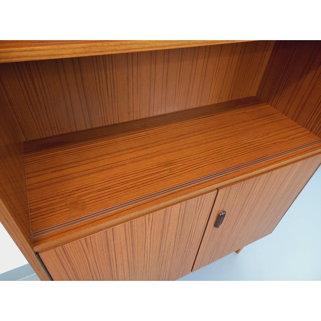 Vintage Scandinavian style storage bookcase from the 60s, in teak-style melamine, pretty teak handle, 2 open shelves in...