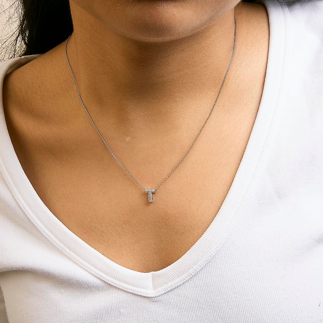 Elegance meets personalized charm in this exquisite pendant, meticulously crafted from radiant 10K white gold with a...