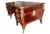 An 1880s faux-partners desk in rosewood, mahogany, doré bronze mounts and gilt tooled leather top. This desk was from...