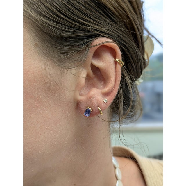 These tanzanite studs bring together timeless design and heartfelt meaning. Set in 14k yellow gold, the emerald-cut 6x4mm...