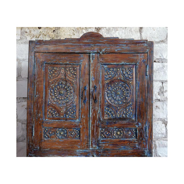 Make a bold statement with this exquisite antique floral carved armoire, finished in a rich distressed blue that...