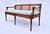 A superb Louis XVI Style Caned settee with new custom cushion in powder blue cotton upholstery. Curved hand carved...
