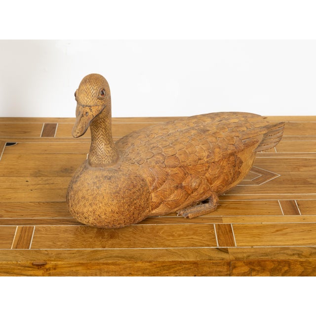 An English Victorian period carved wooden duck sculpture from the 19th century with nicely detailed plumage and brown...