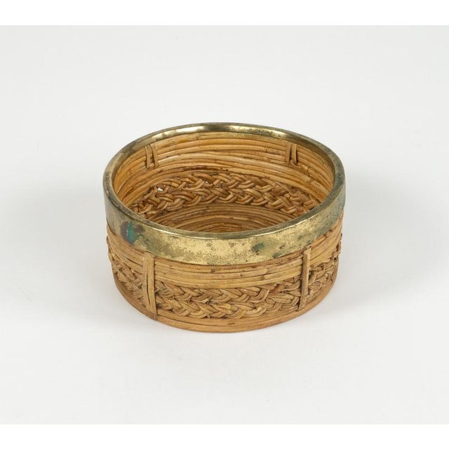 Midcentury beautiful round bowl or centerpiece in bamboo, rattan and brass. Made in Italy in the 1970s. Made of rattan and...
