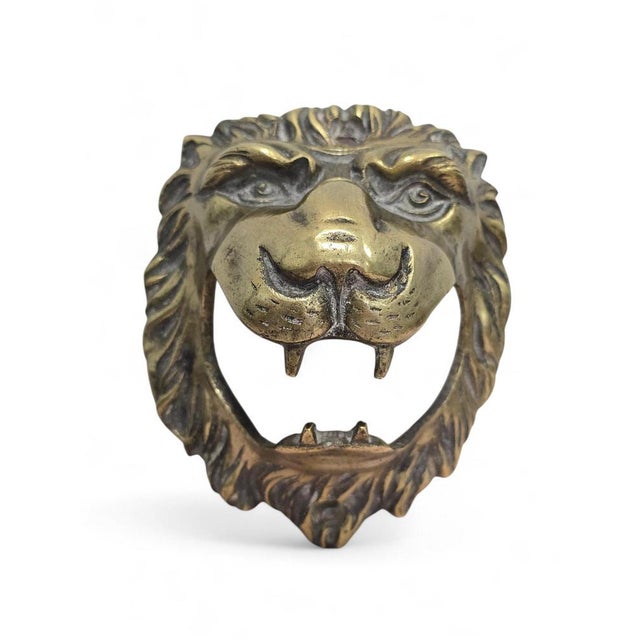 Striking 19th-century bronze sculpture depicting a lion's head, masterfully rendered with exceptional attention to detail....