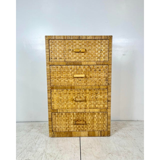 Vintage wrapped rattan tall dresser. Woven caning wrapped tall chest of drawers. Bamboo rattan handles. Finished back can...