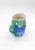 This pitcher features grapes with a green vine handle and leaves around the rim. It is 4.5" tall. The bottom is marked...
