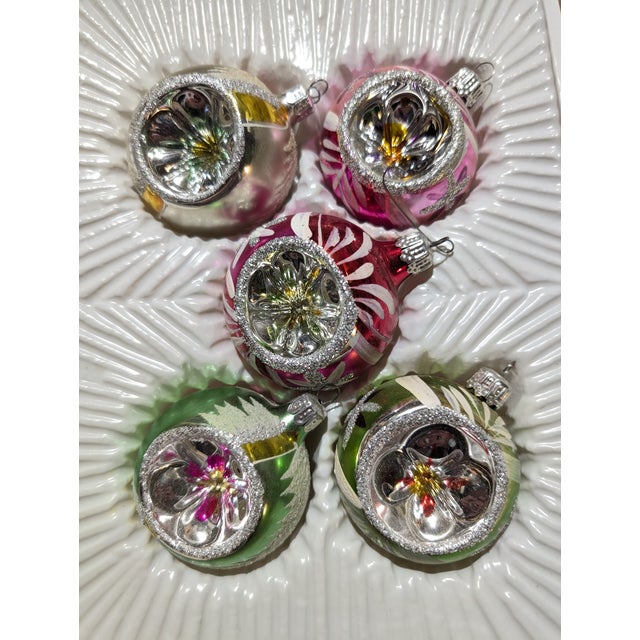 Ten round indented ornaments in the original boxes. Made in Romania.