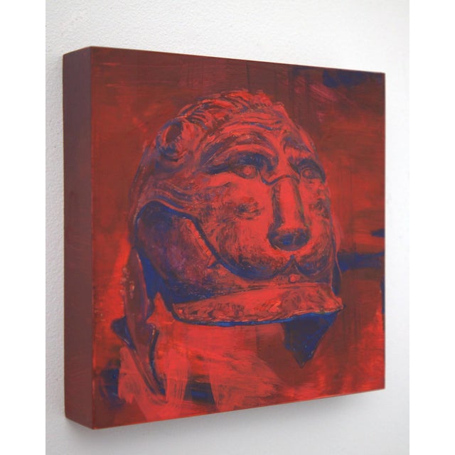 The artwork depicts a stylized representation of a wild animal's head, rendered in bold reds and deep blues that evoke a...