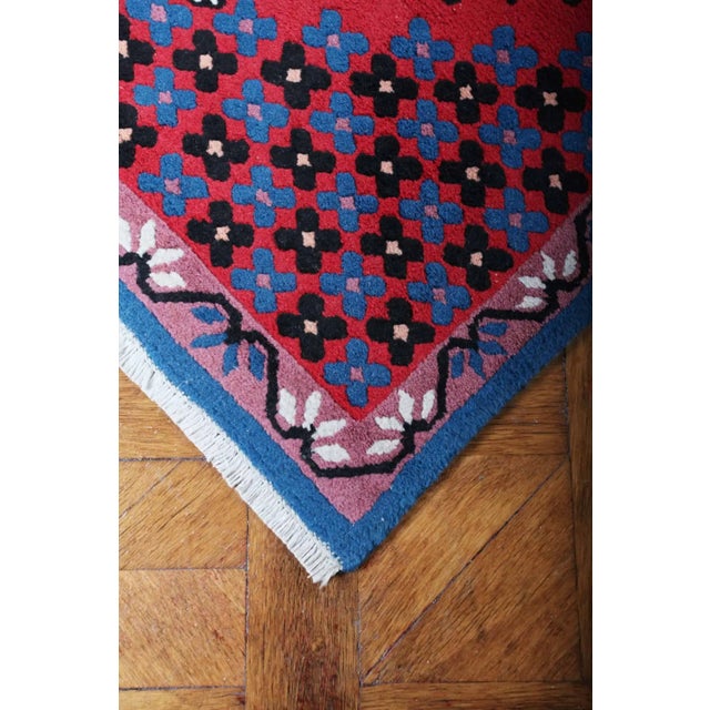 Colorful rug in red and blue colors. The rug is hand-knotted from soft wool. Higher pile on cotton warp. Central...