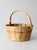 This vintage woven gathering basket pairs warm natural cane with a subtle rosy pink band around the body. Its rounded...