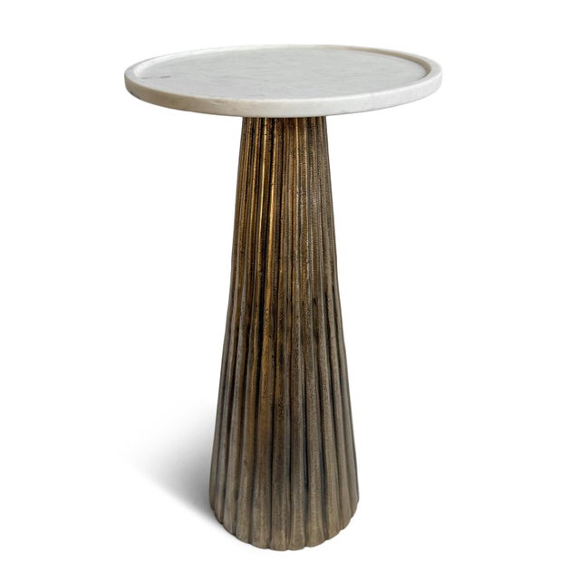 Featuring a beautifully fluted cast aluminum base finished in a warm antique brass, this striking side table brings...