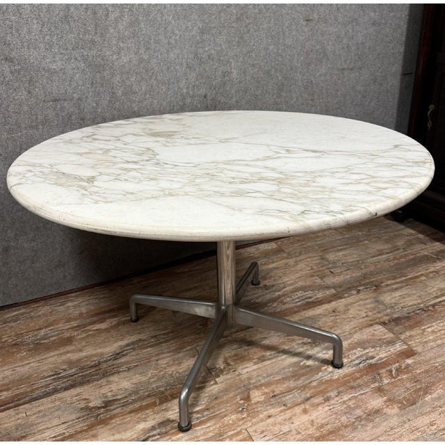 According to Herman Miller, Charles and Ray Eames: Magnificent dining table circa 1970 with a circular Carrara marble top...