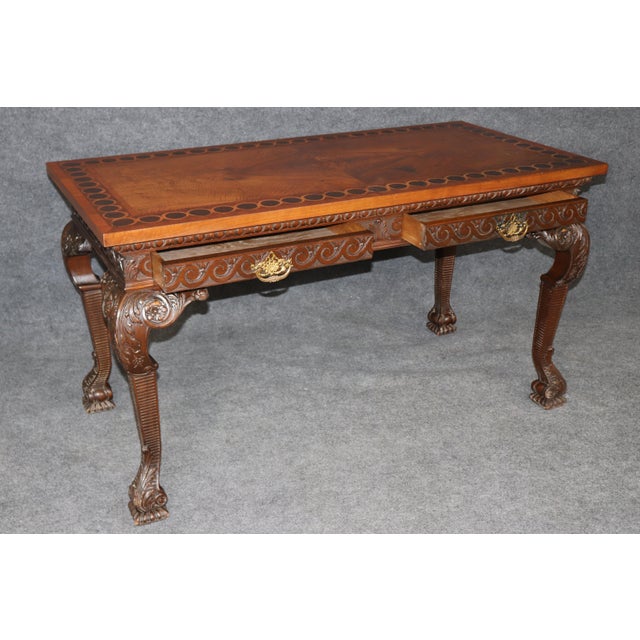 This distinguished walnut console table is an exceptional example of classical craftsmanship, combining elegant...