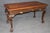 This distinguished walnut console table is an exceptional example of classical craftsmanship, combining elegant...