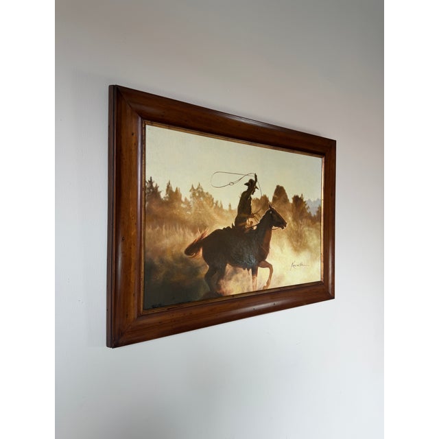Striking vintage Western painting on canvas signed “Kenneth,” depicting a cowboy on horseback swinging a lasso through a...