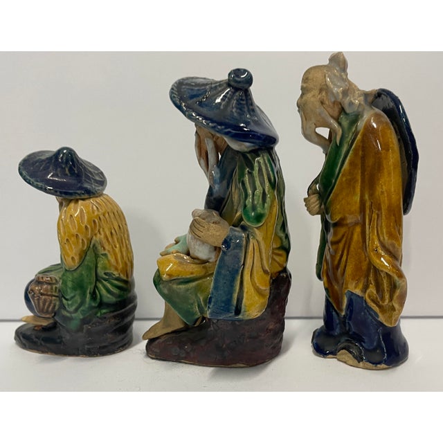 A vintage set of three Chinese Mudmen figures, two of which are marked "China" on the bottom, Height: 5, 4.5, and 3.5...