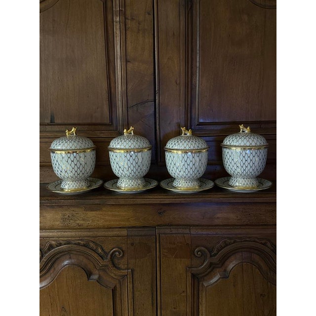A blend of elegance and versatility, this set of four vintage gilt porcelain urns showcases timeless craftsmanship with a...