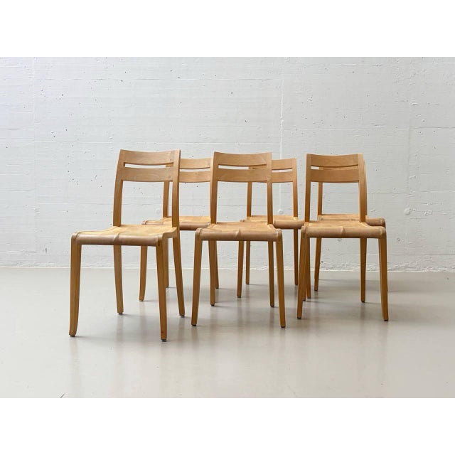 The chair is constructed from molded plywood layers that flow seamlessly from the legs to the seat and then to the...