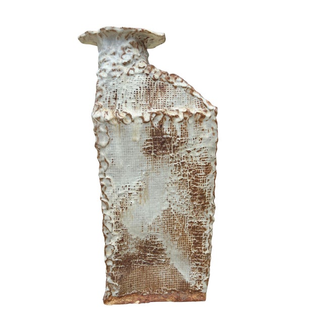 A striking piece of hand-built studio pottery, signed L. Magee and dated January 1969. The vase features a fabric-...