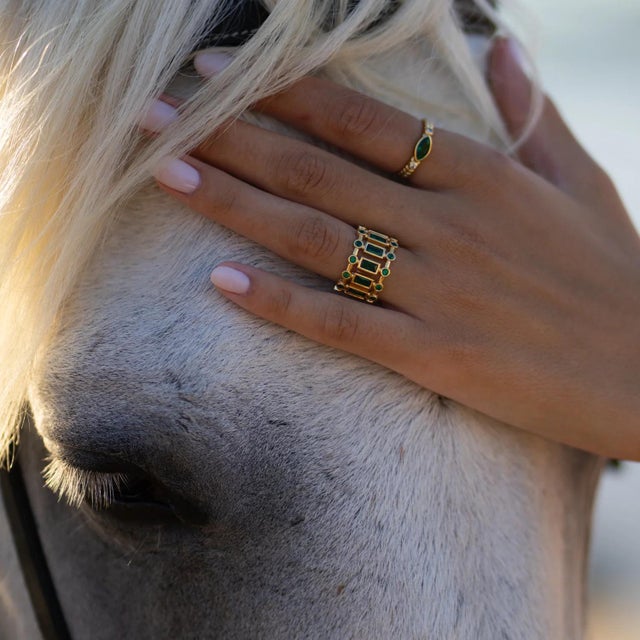 Infused with the vibrant green energy of emeralds, the Radiant Majesty Emerald Gold Adjustable Cuff Ring symbolizes...