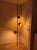 A real statement piece, this dark green tension pole lamp features three adjustable "eyeball" spotlights. The lamp spans...