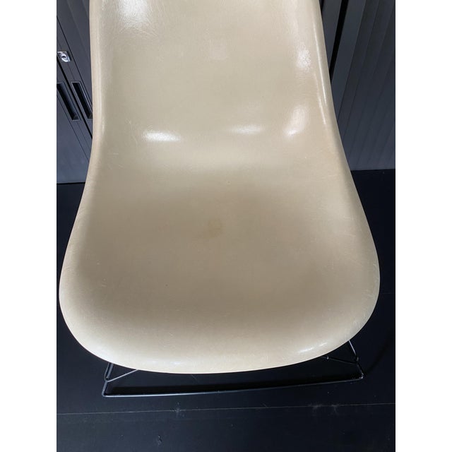 Parchment white fiberglass Cat's Cradle lounge chair base Designed by Charles & Ray Eames Manufactured by Herman Miller...