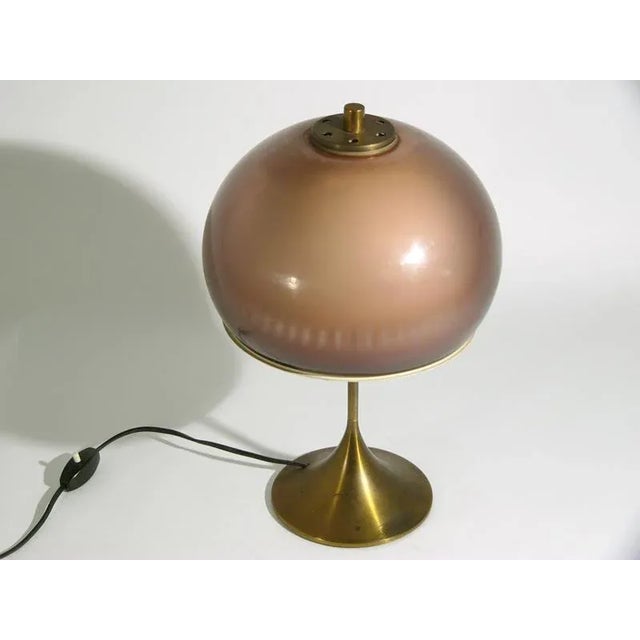 This Italian table lamp was manufactured by Lamter in Milan in the 1960s. It is made from a acrylic glass lampshade and a...