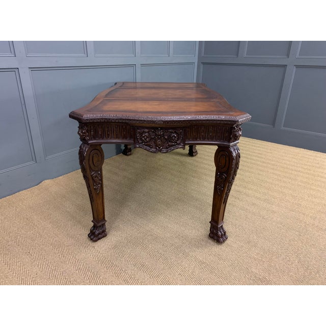 A bold and impressive carved mahogany writing table in the manner of Thomas Chippendale. Of generous proportions, made and...