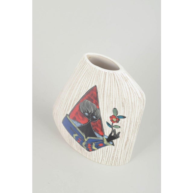 Handmade italian ceramic vase with an asymmetrical, slanted form and textured white-glazed surface. The front features a...