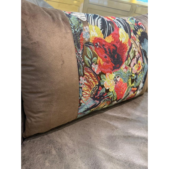 At the center of this lumbar cover sits a woven jacquard panel packed with tropical birds in full motion: a large red...