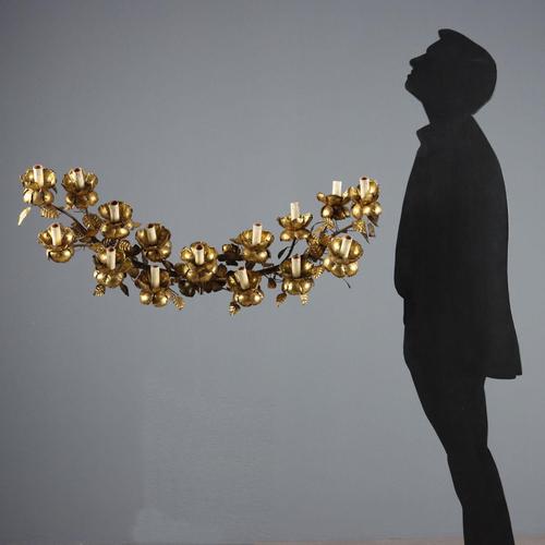 Fifteen-light wall lamp in iron and sheet metal worked with gilded leaves. Italy, late 19th century. This piece is...