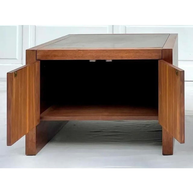 A distinctive vintage mid-century modern cabinet-style side table in the style of Harry Lunstead, featuring a substantial...