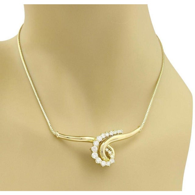 The Jose Hess Diamond 18k Yellow Gold Wide Curved Scroll Necklace is a fine and original piece of vintage jewelry. This...