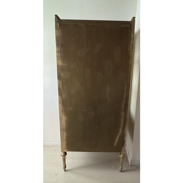 A striking mid-20th century display cabinet crafted in the Baroque style, richly decorated with elaborate carved details...