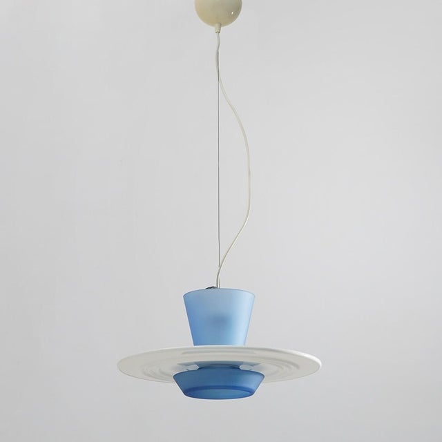 A “zefiro” pendant lamp designed by giuseppe ramella for arteluce in the 1980s, a project that interprets light through a...