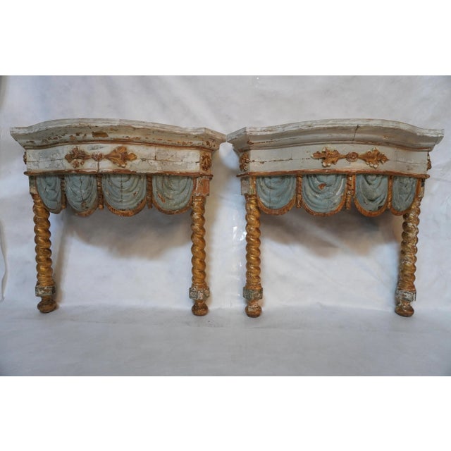 Pair of early 19th-century Italian painted and parcel gilt consoles. Showcases Straight legs with a carved twisted look,...