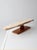 A sculptural antique primitive tabletop ironing board dating to the early 20th century. The long, narrow top rests on a...