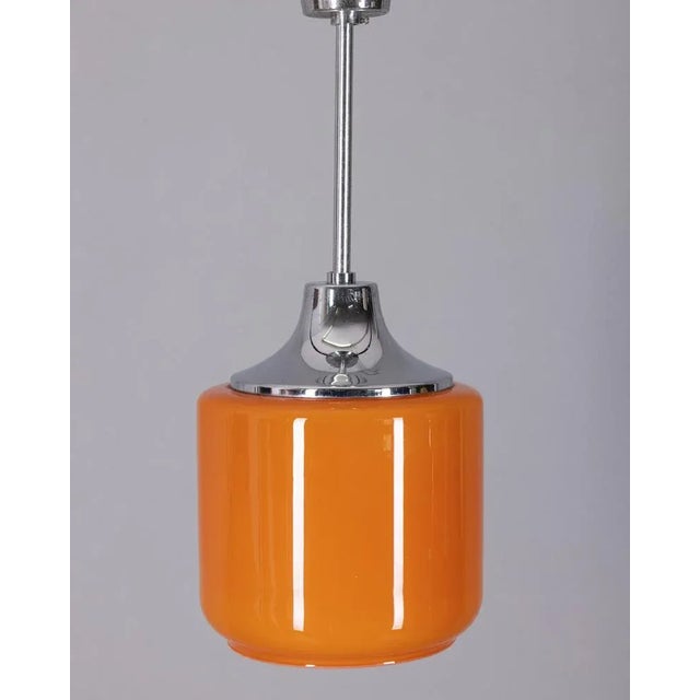 Pendant lamp in chromed metal and orange opal glass lampshade Up to 250V (Europe/UK Standard).The wiring of this item may...